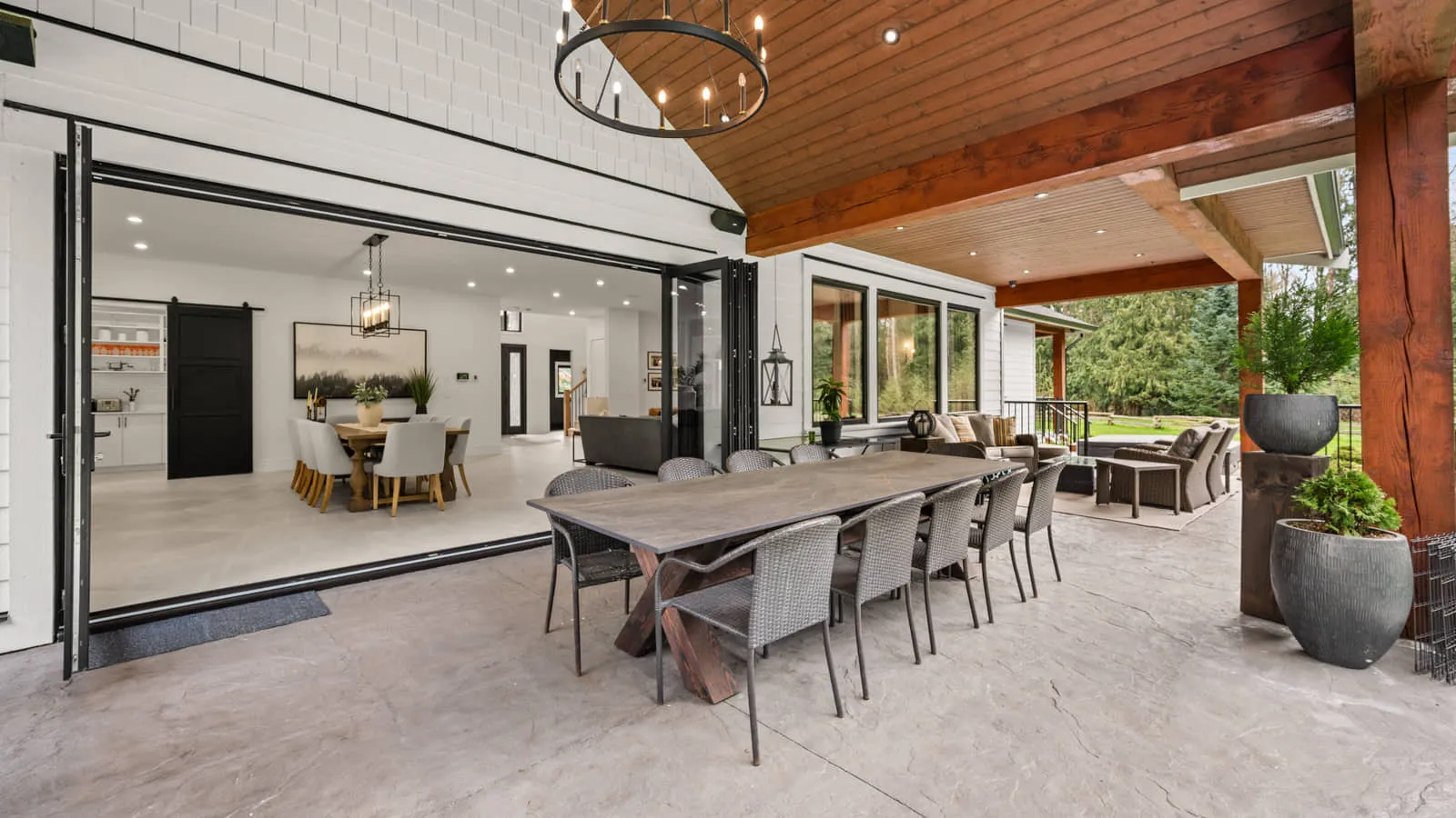 A covered outdoor dining and sitting area opening onto the garden.