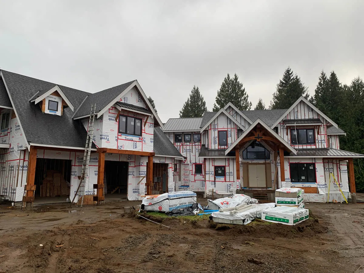 A house mid-build, wrapped and framed, before the exterior finishes go on.